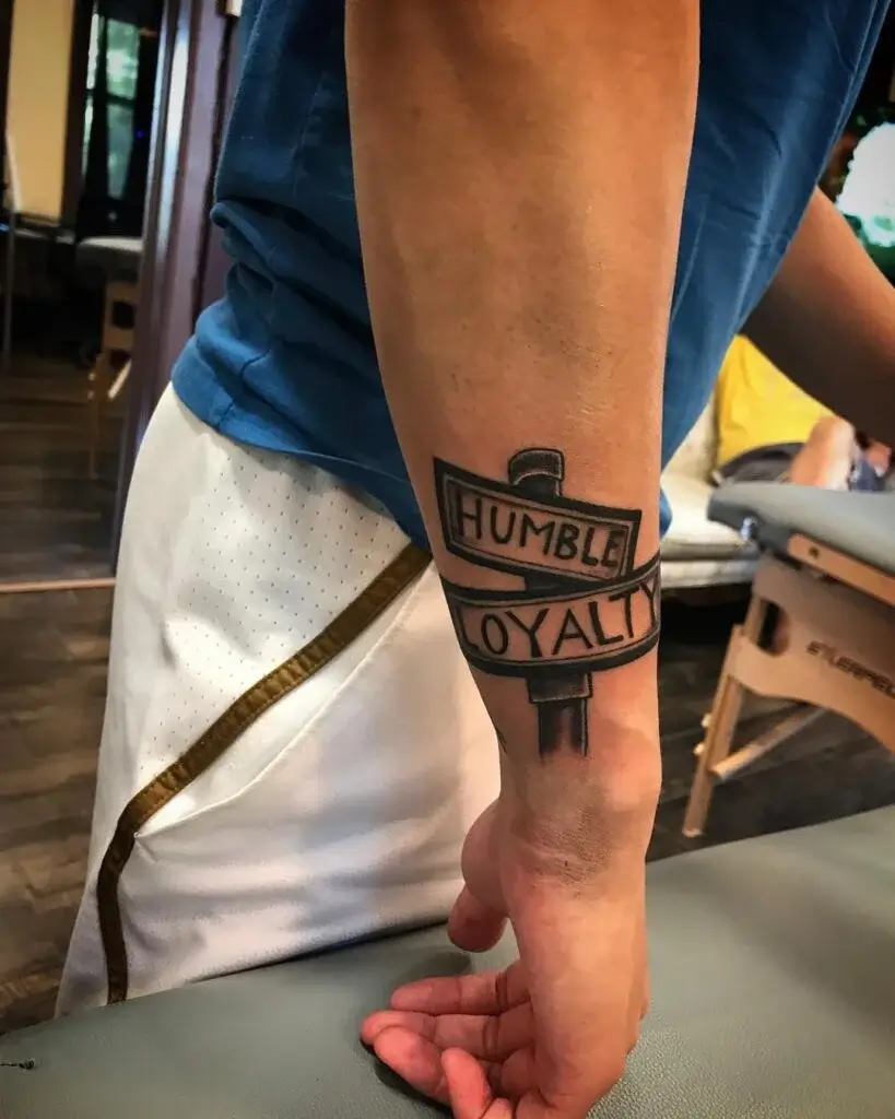 Humble Loyalty Street Sign Tattoo: A Symbol of Dedication