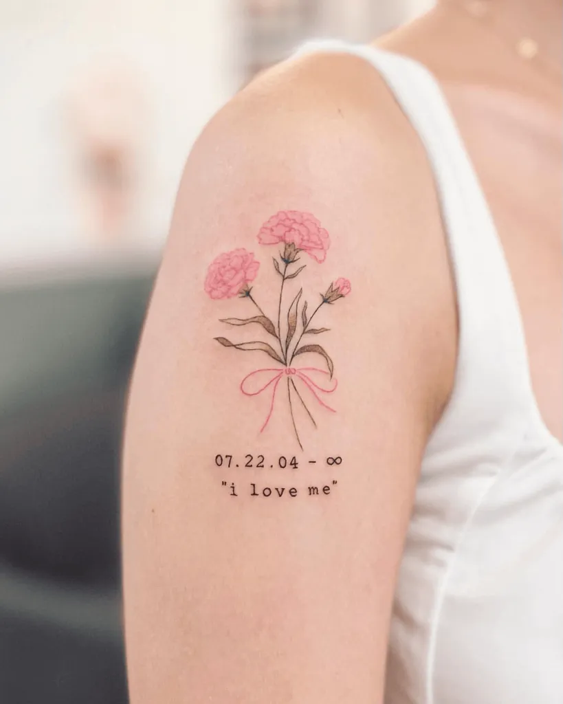 Minimal Tattoo of Carnations with Lettering on Upper Arm