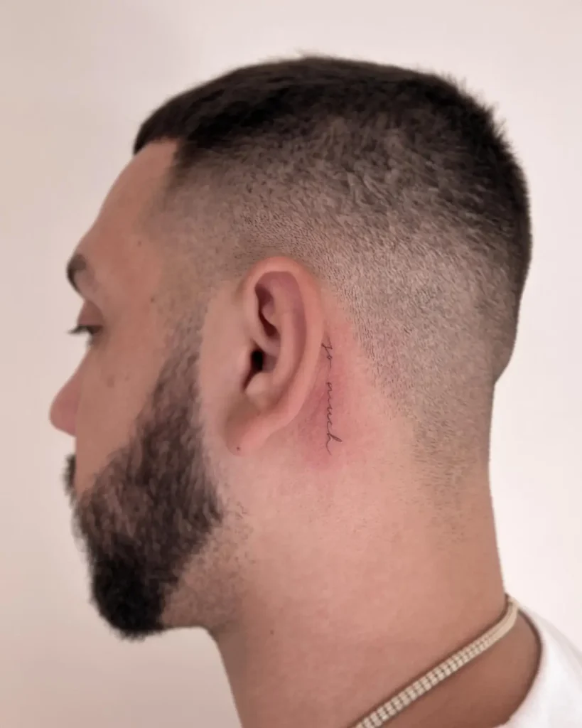 Refined Script Tattoo Behind the Ear