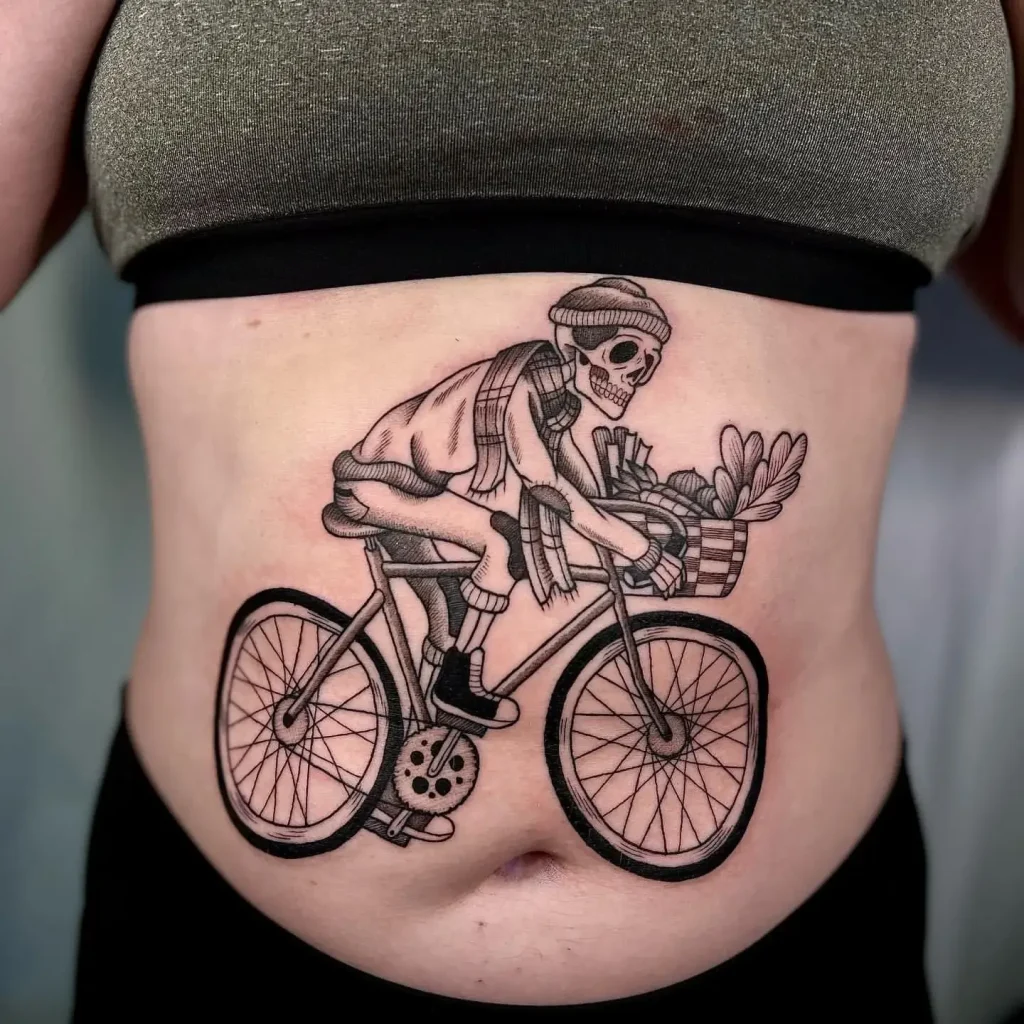 Stomach Tattoo of a Black and Gray Skeleton Cyclist