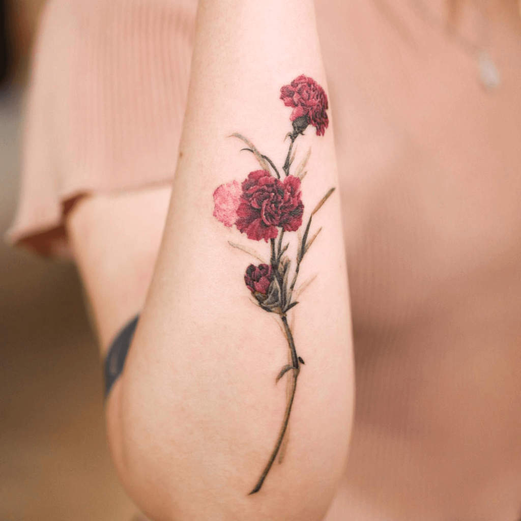 Watercolor Tattoo of Carnations on Lower Arm