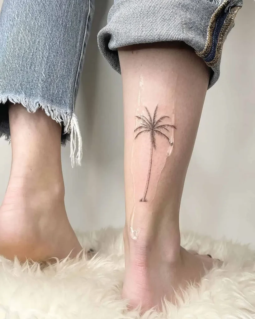 Delicate Palm Tree Tattoo on Back of Woman’s Leg