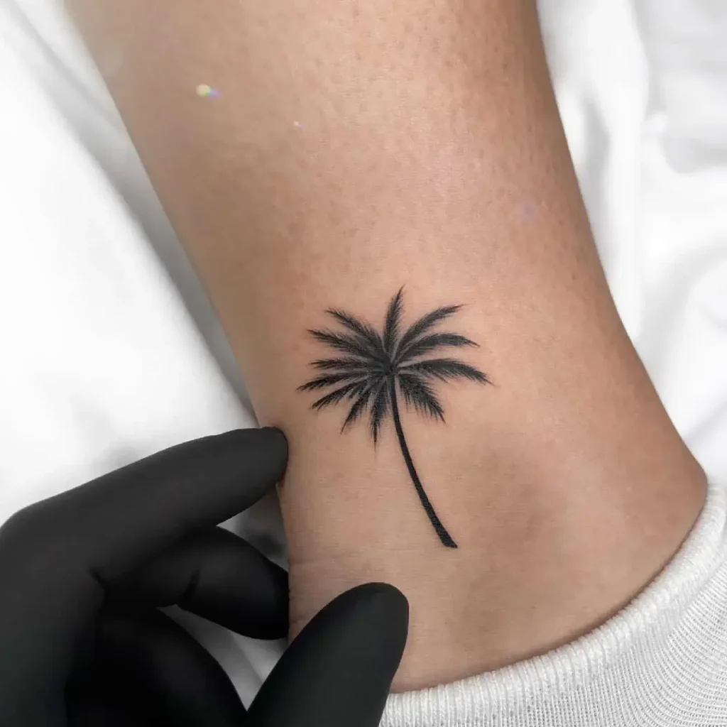 Small Palm Tree Tattoo on Woman’s Ankle