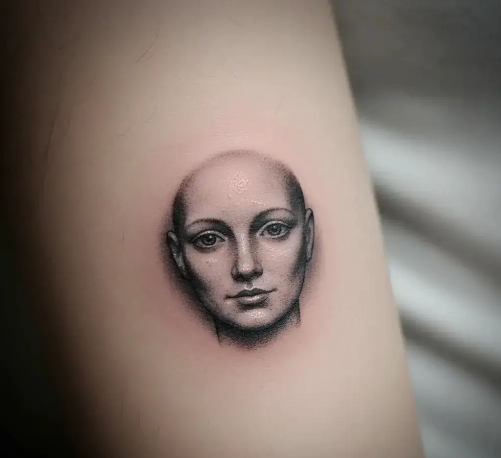 Small Human Face Tattoo