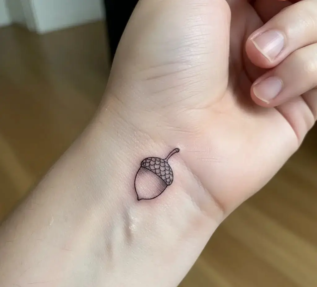 Tiny Acorn Tattoo